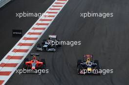 Sebastian Vettel (GER) Red Bull Racing RB8 passes Charles Pic (FRA) Marussia F1 Team MR01. 04.11.2012. Formula 1 World Championship, Rd 18, Abu Dhabi Grand Prix, Yas Marina Circuit, Abu Dhabi, Race Day.