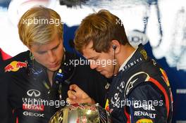 Sebastian Vettel (GER) Red Bull Racing with Heikki Huovinen (FIN) Personal Trainer.