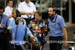 Sebastian Vettel (GER) Red Bull Racing returns is taken to parc ferme by Matteo Bonciani (ITA) FIA Media Delegate after stopping on the track at the end of qualifying.  03.11.2012. Formula 1 World Championship, Rd 18, Abu Dhabi Grand Prix, Yas Marina Circuit, Abu Dhabi, Qualifying Day.