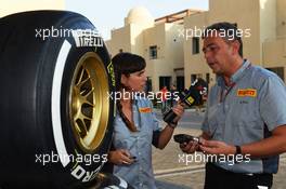 Mario Isola (ITA) Pirelli Racing Manager with Laia Ferrer (ESP) TV3 Televsion Presenter. 01.11.2012. Formula 1 World Championship, Rd 18, Abu Dhabi Grand Prix, Yas Marina Circuit, Abu Dhabi, Preparation Day.