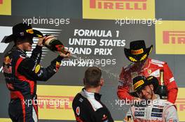 Race winner Lewis Hamilton (GBR) McLaren is sprayed with the champagne by Sebastian Vettel (GER) Red Bull Racing on the podium. 18.11.2012. Formula 1 World Championship, Rd 19, United States Grand Prix, Austin, Texas, USA, Race Day.