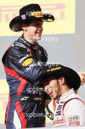 Race winner Lewis Hamilton (GBR) McLaren celebrates on the podium with Sebastian Vettel (GER) Red Bull Racing. 18.11.2012. Formula 1 World Championship, Rd 19, United States Grand Prix, Austin, Texas, USA, Race Day.