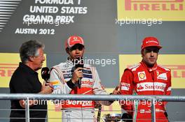(L to R): Mario Andretti (USA) with race winner Lewis Hamilton (GBR) McLaren and Fernando Alonso (ESP) Ferrari on the podium. 18.11.2012. Formula 1 World Championship, Rd 19, United States Grand Prix, Austin, Texas, USA, Race Day.