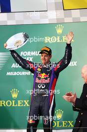 Sebastian Vettel (GER) Red Bull Racing celebrates his third position on the podium. 17.03.2013. Formula 1 World Championship, Rd 1, Australian Grand Prix, Albert Park, Melbourne, Australia, Race Day.