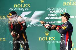 (L to R): Kimi Raikkonen (FIN) Lotus F1 Team and Sebastian Vettel (GER) Red Bull Racing celebrate on the podium. 17.03.2013. Formula 1 World Championship, Rd 1, Australian Grand Prix, Albert Park, Melbourne, Australia, Race Day.