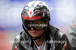 McLaren mechanic with pit stop helmet. 01.03.2013. Formula One Testing, Day Two, Barcelona, Spain.