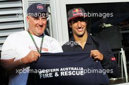 Daniel Ricciardo (AUS) Scuderia Toro Rosso with a Fireman from his home town. 23.08.2013. Formula 1 World Championship, Rd 11, Belgian Grand Prix, Spa Francorchamps, Belgium, Practice Day.