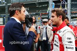 Jules Bianchi (FRA) Marussia F1 Team with Thomas Senecal (FRA) Canal+ F1 Chief Editor and TV Presenter on the grid. 25.08.2013. Formula 1 World Championship, Rd 11, Belgian Grand Prix, Spa Francorchamps, Belgium, Race Day.