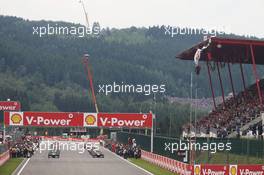 The grid before the start of the race as Greenpeace make a protest against race title sponsors Shell on the roof of the main grandstand. 25.08.2013. Formula 1 World Championship, Rd 11, Belgian Grand Prix, Spa Francorchamps, Belgium, Race Day.