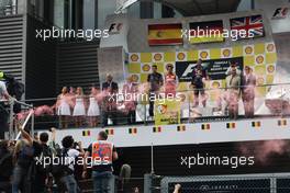 The podium (L to R): Fernando Alonso (ESP) Ferrari, second; Sebastian Vettel (GER) Red Bull Racing, race winner; Lewis Hamilton (GBR) Mercedes AMG F1, third. Greenpeace make a protest against race title sponsors Shell. 25.08.2013. Formula 1 World Championship, Rd 11, Belgian Grand Prix, Spa Francorchamps, Belgium, Race Day.