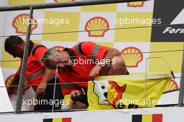 A Shell protest by Greenpeace is removed from the podium. 25.08.2013. Formula 1 World Championship, Rd 11, Belgian Grand Prix, Spa Francorchamps, Belgium, Race Day.