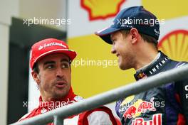 (L to R): Fernando Alonso (ESP) Ferrari and race winner Sebastian Vettel (GER) Red Bull Racing on the podium. 25.08.2013. Formula 1 World Championship, Rd 11, Belgian Grand Prix, Spa Francorchamps, Belgium, Race Day.