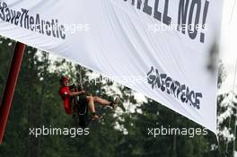 Greenpeace make a protest against race title sponsors Shell on the roof of the main grandstand. 25.08.2013. Formula 1 World Championship, Rd 11, Belgian Grand Prix, Spa Francorchamps, Belgium, Race Day.