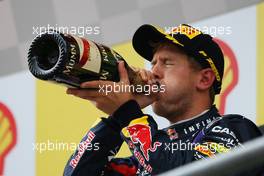 Race winner Sebastian Vettel (GER) Red Bull Racing celebrates with the champagne on the podium. 25.08.2013. Formula 1 World Championship, Rd 11, Belgian Grand Prix, Spa Francorchamps, Belgium, Race Day.