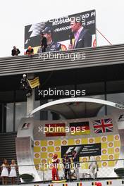 The podium (L to R): Fernando Alonso (ESP) Ferrari, second; Sebastian Vettel (GER) Red Bull Racing, race winner; David Coulthard (GBR) Red Bull Racing and Scuderia Toro Advisor / BBC Television Commentator; Lewis Hamilton (GBR) Mercedes AMG F1, third. Greenpeace make a protest against race title sponsors Shell. 25.08.2013. Formula 1 World Championship, Rd 11, Belgian Grand Prix, Spa Francorchamps, Belgium, Race Day.