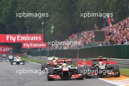 Sergio Perez (MEX) McLaren MP4-28 and Romain Grosjean (FRA) Lotus F1 E21 battle for position. 25.08.2013. Formula 1 World Championship, Rd 11, Belgian Grand Prix, Spa Francorchamps, Belgium, Race Day.