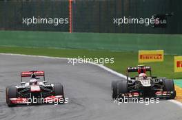 (L to R): Jenson Button (GBR) McLaren MP4-28 and Romain Grosjean (FRA) Lotus F1 E21 battle for position. 25.08.2013. Formula 1 World Championship, Rd 11, Belgian Grand Prix, Spa Francorchamps, Belgium, Race Day.
