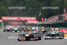 Sebastian Vettel (GER) Red Bull Racing RB9 leads Lewis Hamilton (GBR) Mercedes AMG F1 W04 at the start of the race. 25.08.2013. Formula 1 World Championship, Rd 11, Belgian Grand Prix, Spa Francorchamps, Belgium, Race Day.