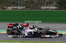 Esteban Gutierrez (MEX) Sauber C32 and Kimi Raikkonen (FIN) Lotus F1 E21 battle for position. 25.08.2013. Formula 1 World Championship, Rd 11, Belgian Grand Prix, Spa Francorchamps, Belgium, Race Day.