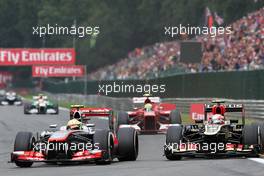(L to R): Sergio Perez (MEX) McLaren MP4-28 and Romain Grosjean (FRA) Lotus F1 E21 battle for position. 25.08.2013. Formula 1 World Championship, Rd 11, Belgian Grand Prix, Spa Francorchamps, Belgium, Race Day.