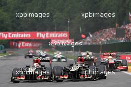 Romain Grosjean (FRA) Lotus F1 E21 and Kimi Raikkonen (FIN) Lotus F1 E21 (Right) battle for position. 25.08.2013. Formula 1 World Championship, Rd 11, Belgian Grand Prix, Spa Francorchamps, Belgium, Race Day.