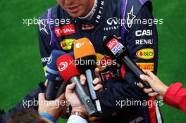 Sebastian Vettel (GER) Red Bull Racing with the media. 24.08.2013. Formula 1 World Championship, Rd 11, Belgian Grand Prix, Spa Francorchamps, Belgium, Qualifying Day.