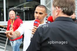 Lewis Hamilton (GBR) Mercedes AMG F1 describes his pole lap with Martin Brundle (GBR) Sky Sports Commentator in the paddock. 24.08.2013. Formula 1 World Championship, Rd 11, Belgian Grand Prix, Spa Francorchamps, Belgium, Qualifying Day.