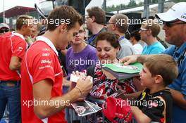 Jules Bianchi (FRA) Marussia F1 Team signs autographs for the fans. 22.08.2013. Formula 1 World Championship, Rd 11, Belgian Grand Prix, Spa Francorchamps, Belgium, Preparation Day.