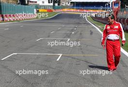 Hirohide Hamashima (JPN), Scuderia Ferrari has a look at the groves on the grid. 22.08.2013. Formula 1 World Championship, Rd 11, Belgian Grand Prix, Spa Francorchamps, Belgium, Preparation Day.