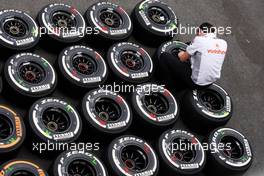 McLaren mechanic with Pirelli tyres. 22.08.2013. Formula 1 World Championship, Rd 11, Belgian Grand Prix, Spa Francorchamps, Belgium, Preparation Day.