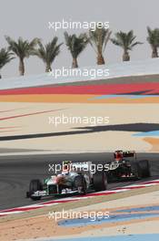 Adrian Sutil (GER) Sahara Force India VJM06 leads Kimi Raikkonen (FIN) Lotus F1 E21. 19.04.2013. Formula 1 World Championship, Rd 4, Bahrain Grand Prix, Sakhir, Bahrain, Practice Day