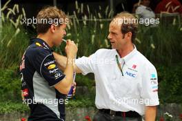(L to R): Sebastian Vettel (GER) Red Bull Racing with Joseph Lieberer (SUI) Sauber Physio. 19.04.2013. Formula 1 World Championship, Rd 4, Bahrain Grand Prix, Sakhir, Bahrain, Practice Day