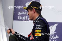 Race winner Sebastian Vettel (GER) Red Bull Racing celebrates on the podium. 21.04.2013. Formula 1 World Championship, Rd 4, Bahrain Grand Prix, Sakhir, Bahrain, Race Day