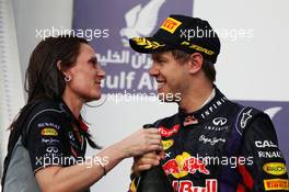 Race winner Sebastian Vettel (GER) Red Bull Racing celebrates on the podium with Gill Jones (GBR) Red Bull Racing Electronics. 21.04.2013. Formula 1 World Championship, Rd 4, Bahrain Grand Prix, Sakhir, Bahrain, Race Day