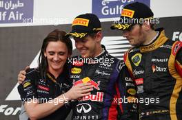 Race winner Sebastian Vettel (GER) Red Bull Racing celebrates with Gill Jones (GBR) Red Bull Racing Electronics and third placed Romain Grosjean (FRA) Lotus F1 Team on the podium. 21.04.2013. Formula 1 World Championship, Rd 4, Bahrain Grand Prix, Sakhir, Bahrain, Race Day