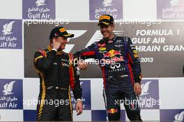 Kimi Raikkonen (FIN) Lotus F1 Team with Sebastian Vettel (GER) Red Bull Racing  21.04.2013. Formula 1 World Championship, Rd 4, Bahrain Grand Prix, Sakhir, Bahrain, Race Day