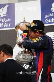 Race winner Sebastian Vettel (GER) Red Bull Racing celebrates on the podium. 21.04.2013. Formula 1 World Championship, Rd 4, Bahrain Grand Prix, Sakhir, Bahrain, Race Day