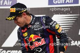 Race winner Sebastian Vettel (GER) Red Bull Racing celebrates on the podium. 21.04.2013. Formula 1 World Championship, Rd 4, Bahrain Grand Prix, Sakhir, Bahrain, Race Day