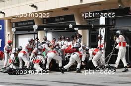 Jenson Button (GBR) McLaren MP4-28 makes a pit stop. 21.04.2013. Formula 1 World Championship, Rd 4, Bahrain Grand Prix, Sakhir, Bahrain, Race Day