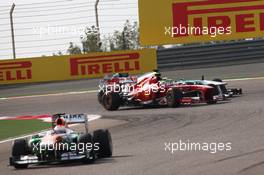 Paul di Resta (GBR) Sahara Force India VJM06 leads a battling Felipe Massa (BRA) Ferrari F138 and Nico Rosberg (GER) Mercedes AMG F1 W04. 21.04.2013. Formula 1 World Championship, Rd 4, Bahrain Grand Prix, Sakhir, Bahrain, Race Day