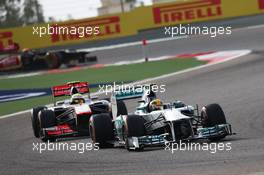 Lewis Hamilton (GBR) Mercedes AMG F1 W04 leads Sergio Perez (MEX) McLaren MP4-28. 21.04.2013. Formula 1 World Championship, Rd 4, Bahrain Grand Prix, Sakhir, Bahrain, Race Day