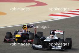 Pastor Maldonado (VEN) Williams FW35 battles for position with Mark Webber (AUS) Red Bull Racing RB9. 21.04.2013. Formula 1 World Championship, Rd 4, Bahrain Grand Prix, Sakhir, Bahrain, Race Day
