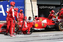 Fernando Alonso (ESP) Ferrari F138 makes a pit stop with his rear wing DRS flap stuck open. 21.04.2013. Formula 1 World Championship, Rd 4, Bahrain Grand Prix, Sakhir, Bahrain, Race Day