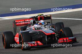 Jenson Button (GBR) McLaren MP4-28 leads Romain Grosjean (FRA) Lotus F1 E21. 21.04.2013. Formula 1 World Championship, Rd 4, Bahrain Grand Prix, Sakhir, Bahrain, Race Day