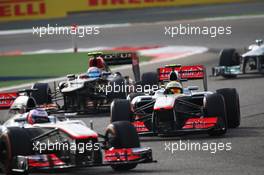 Jenson Button (GBR) McLaren MP4-28 leads  team mate Sergio Perez (MEX) McLaren MP4-28 and Romain Grosjean (FRA) Lotus F1 E21. 21.04.2013. Formula 1 World Championship, Rd 4, Bahrain Grand Prix, Sakhir, Bahrain, Race Day