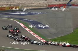 Sergio Perez (MEX) McLaren MP4-28 leads rge and Lewis Hamilton (GBR) Mercedes AMG F1 W04 at the start of the race. 21.04.2013. Formula 1 World Championship, Rd 4, Bahrain Grand Prix, Sakhir, Bahrain, Race Day