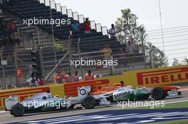 Paul di Resta (GBR) Sahara Force India VJM06 and Nico Rosberg (GER) Mercedes AMG F1 W04 battle for position. 21.04.2013. Formula 1 World Championship, Rd 4, Bahrain Grand Prix, Sakhir, Bahrain, Race Day