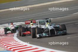 Nico Rosberg (GER) Mercedes AMG F1 W04 leads Sergio Perez (MEX) McLaren MP4-28. 21.04.2013. Formula 1 World Championship, Rd 4, Bahrain Grand Prix, Sakhir, Bahrain, Race Day