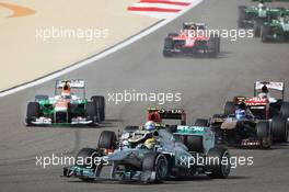 Lewis Hamilton (GBR) Mercedes AMG F1 W04 at the start of the race as Adrian Sutil (GER) Sahara Force India VJM06 suffers a puncture. 21.04.2013. Formula 1 World Championship, Rd 4, Bahrain Grand Prix, Sakhir, Bahrain, Race Day