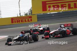 Romain Grosjean (FRA) Lotus F1 E21 leads team mate Jenson Button (GBR) McLaren MP4-28 and Sergio Perez (MEX) McLaren MP4-28. 21.04.2013. Formula 1 World Championship, Rd 4, Bahrain Grand Prix, Sakhir, Bahrain, Race Day